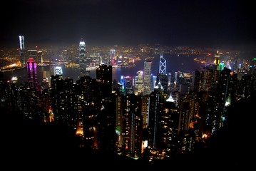 High angle night view of the Victoria Harbor. View from the Victoria Peak a hill on the western half of Hong Kong Island.