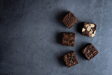 Fototapeta na wymiar brownies cut in squares. Dark food photography concept