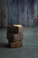brownies cut in squares. Dark food photography concept
