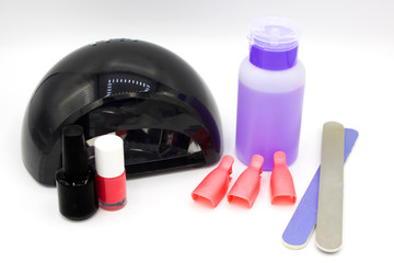 Obraz premium Nail polish, manicure tools on white background top flat lay. How to do manicure at home concept. Do shellac manicure nail care while staying at home during quarantine, top view, space for text