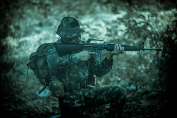 Soldier action with gun on hand holding to protect, survey around safety area in soldier mission with white smoke background.