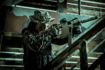 Soldier action with gun on hand holding to protect, survey around safety area in soldier mission...