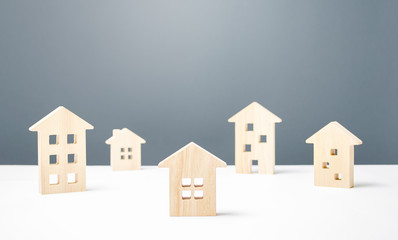 Many wooden figures of residential buildings. Affordable comfortable housing. Urban studies and science. Good modern neighborhood. Search purchase best option apartment and real estate, rent and sale.
