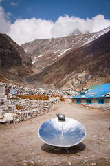 Warming the teapot in a solar cooker. Ecology concept. Renewable green energy. Nepal. Himalaya.