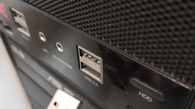 Close-up flash drive is inserted into the computer in the USB port.