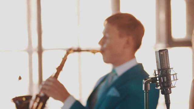 Jazz duet on stage restaurant. Vocalist. Saxophonist. Retro style. Spotlights Music band