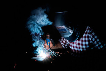 man welding in an industrial workshop