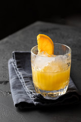 Crystal glass with orange juice and ice decorated with orange slice. Refreshment  fruit beverage  for hot  summer days.