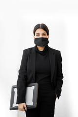 Masked woman. A woman dressed up in office or student attire wearing a mask during pandemic covid-19.