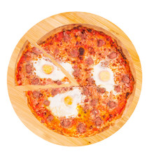 Italian pizza with beef sausages, eggs and bacon, with a slice removed on a wooden platter, isolated on white background with clipping path, top view