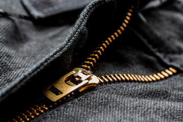 Black jeans with lock zipper. Close up background