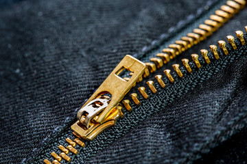Close up black jeans material and gold zipper macro photography on blur background - 352800177