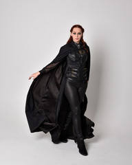fantasy portrait of a woman with red hair wearing dark leather assassin costume with long black...