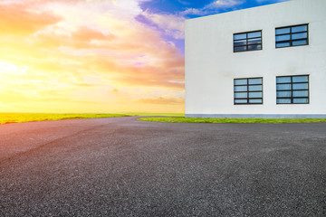 Asphalt road ground and green grass with building.