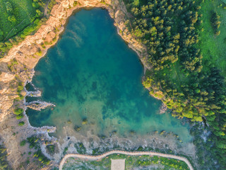Fototapeta na wymiar Aerial drone photo of Quarry turquiose lake colour, open pit mining in Park Grodek, Jaworzno. Poland.