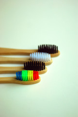 Wooden colored toothbrushes on a light background