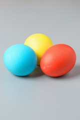 Colorful Easter eggs on a gray background. Easter eggs background. Easter eggs are a symbol and a mandatory attribute of the holiday.