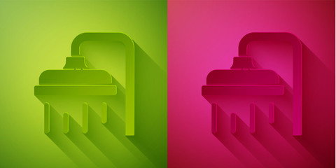 Paper cut Shower head with water drops flowing icon isolated on green and pink background. Paper art style. Vector Illustration