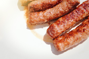 ready-made meat sausages chimpchichi lie on a white plate
