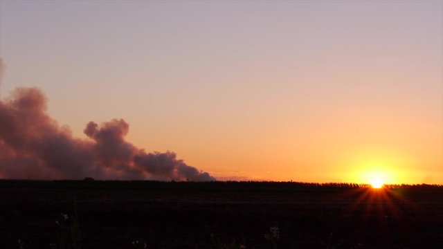 Land, bush fire in the outback at sunrise, smoke bellowing Australia
