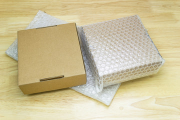 Bubbles covering the box by bubble wrap for protection product cracked on wood table