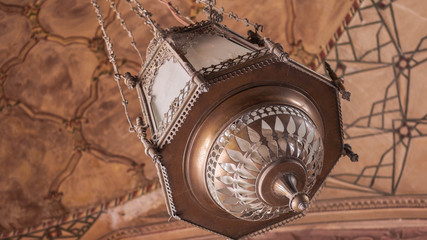 Copper made lantern hanging by the ceiling