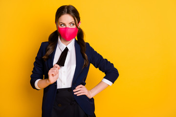 Portrait of her she nice attractive cute pretty curious minded brown-haired schoolgirl wearing pink mask pulling tie posing thinking isolated on bright vivid shine vibrant yellow color background