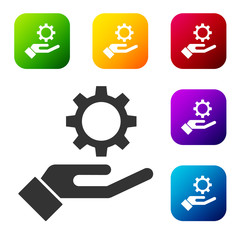 Black Settings in the hand icon isolated on white background. Set icons in color square buttons. Vector Illustration
