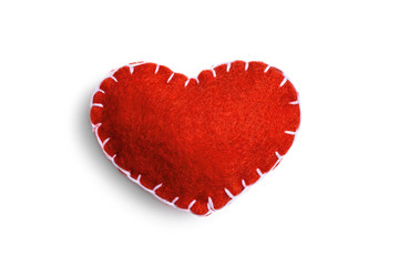 Handmade red heart made of felt stitched with white thread isolated on a white background.