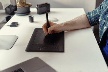 Graphic Designer working hands with interactive pen display, digital Drawing tablet and Pen. Concept of young people works mobile devices. © arthurhidden