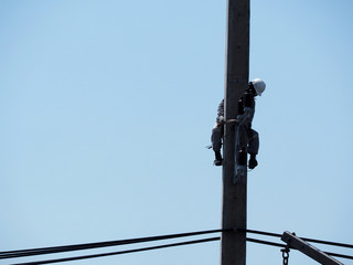 Obraz premium electrician man working at height and dangerous ,high voltage power line maintenance