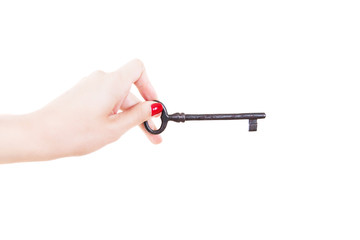Female hand holds an old key. Isolated on white background.