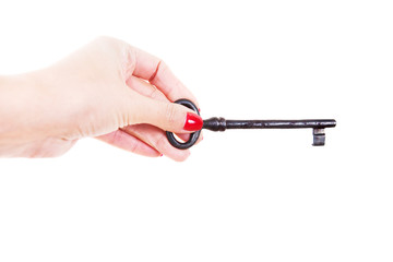 Female hand holds an old key. Isolated on white background.