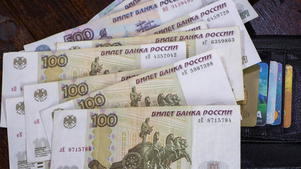 Lot with Russian rubles is on the wallet with credit cards.Paper banknotes Russian Rubles.Rubles is the national currency of Russia.bank of Russia.A thousand rubles close-up.Fall or rise of the ruble