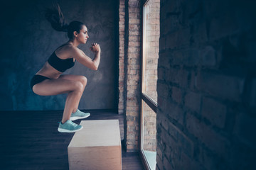 Profile side view of her she nice-looking attractive sportive strong slim thin lady working out program body sculpt at industrial loft brick style interior indoors