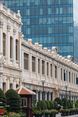 Old French Colonial Architecture in contrast with new and modern architecture in Ho Chi Minh City, Vietnam