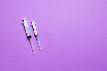 Top view of medical syringes on colorful background. Health care concept with copy space