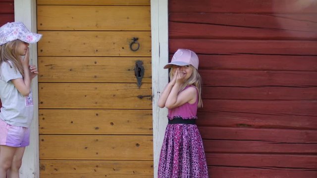 Sisters playing tricks, girls pulling pranks in idyllic Swedish summer environment