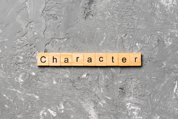 CHARACTER word written on wood block. CHARACTER text on cement table for your desing, concept