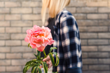 A woman holding cut peony.