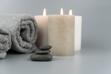 Fototapeta na wymiar Towel with aromatic candles. Aromatherapy and beauty. Concept set of harmony, massage, balance and meditation, spa, relax, beauty spa treatment.
