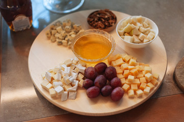 Cheese plate. Cheese set on a round wooden dish