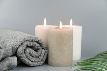 Plakat Towel with aromatic candles. Aromatherapy and beauty. Concept set of harmony, massage, balance and meditation, spa, relax, beauty spa treatment.
