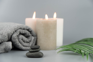 Fototapeta na wymiar Towel with aromatic candles. Aromatherapy and beauty. Concept set of harmony, massage, balance and meditation, spa, relax, beauty spa treatment.