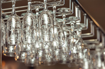 Lots of wine glasses hanging upside down