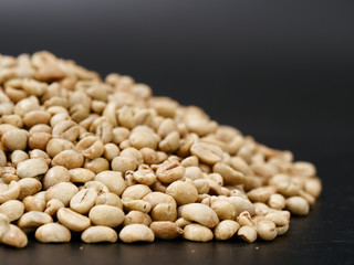 raw not roasted coffee beans from africa on a dark background