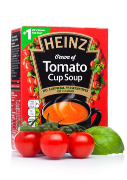 LONDON, UK - NOVEMBER 08, 2019: Pack of Heinz cream of Tomato cup soup on white background with basill and fresh tomatoes.