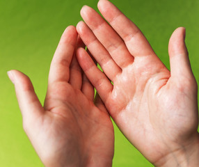 Human hands use a gel, disinfectant, antiseptic in a bubble, jar on a green background