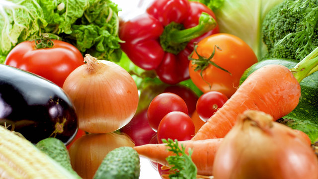 Closeup image of big assortment of fresh ripe vegetable on reflective surface