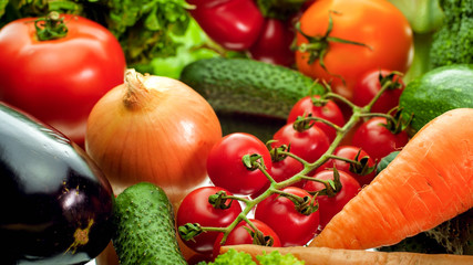 Closeup image of onions, cucumber, carrot, bell pepper, eggplant and salad leaves